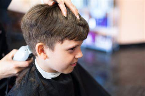 Niño en silla temática durante corte de pelo